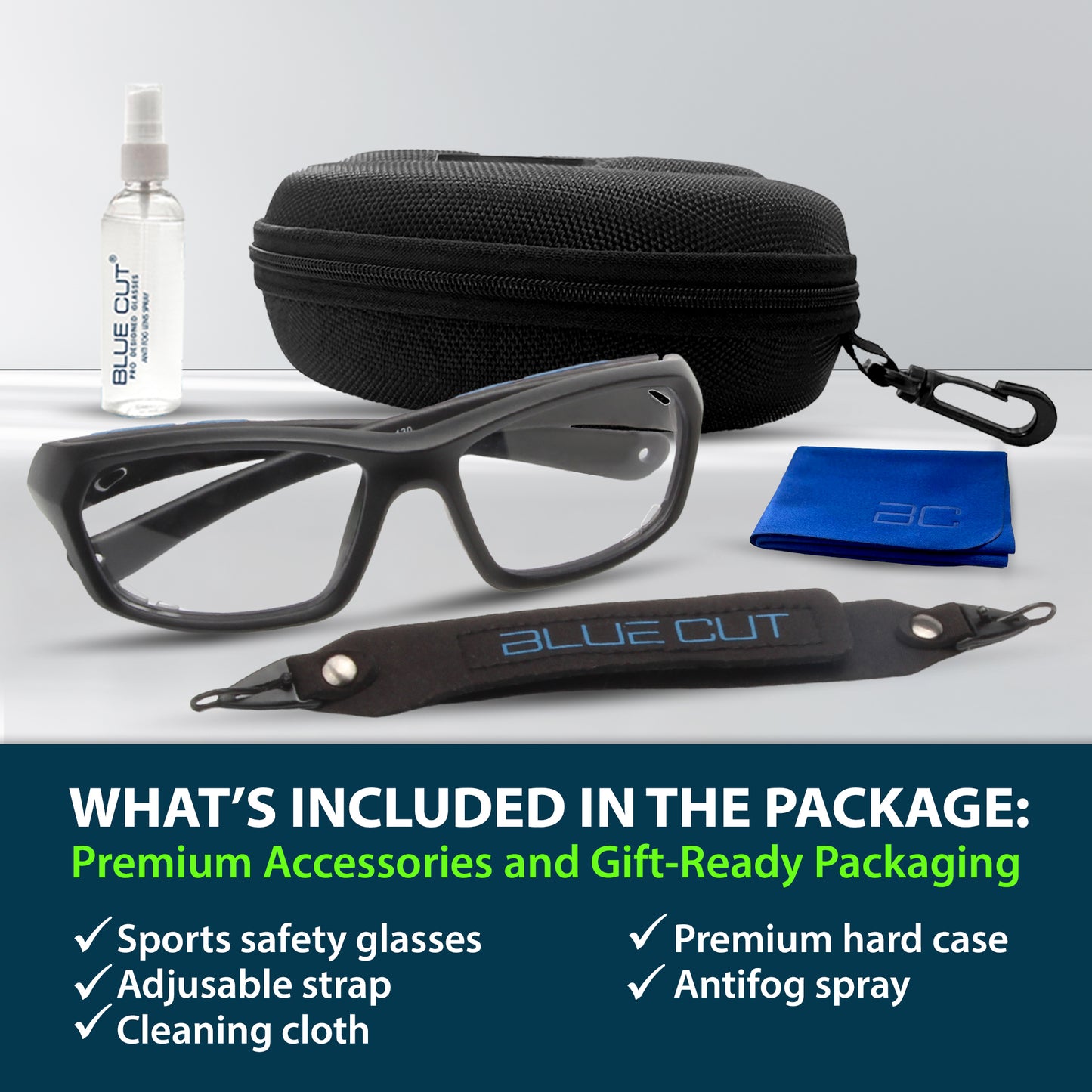Sports safety glasses with accessories including a hard case, antifog spray, and cleaning cloth on a white background.