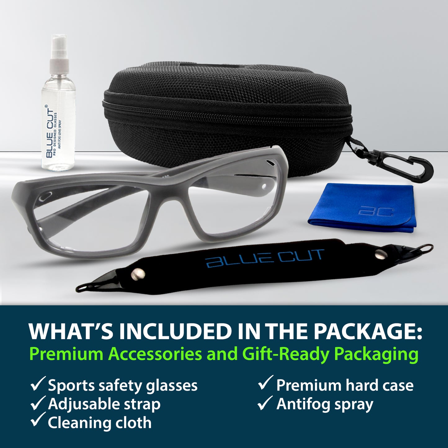 Sports safety glasses with accessories including a hard case, antifog spray, and cleaning cloth on a white background.