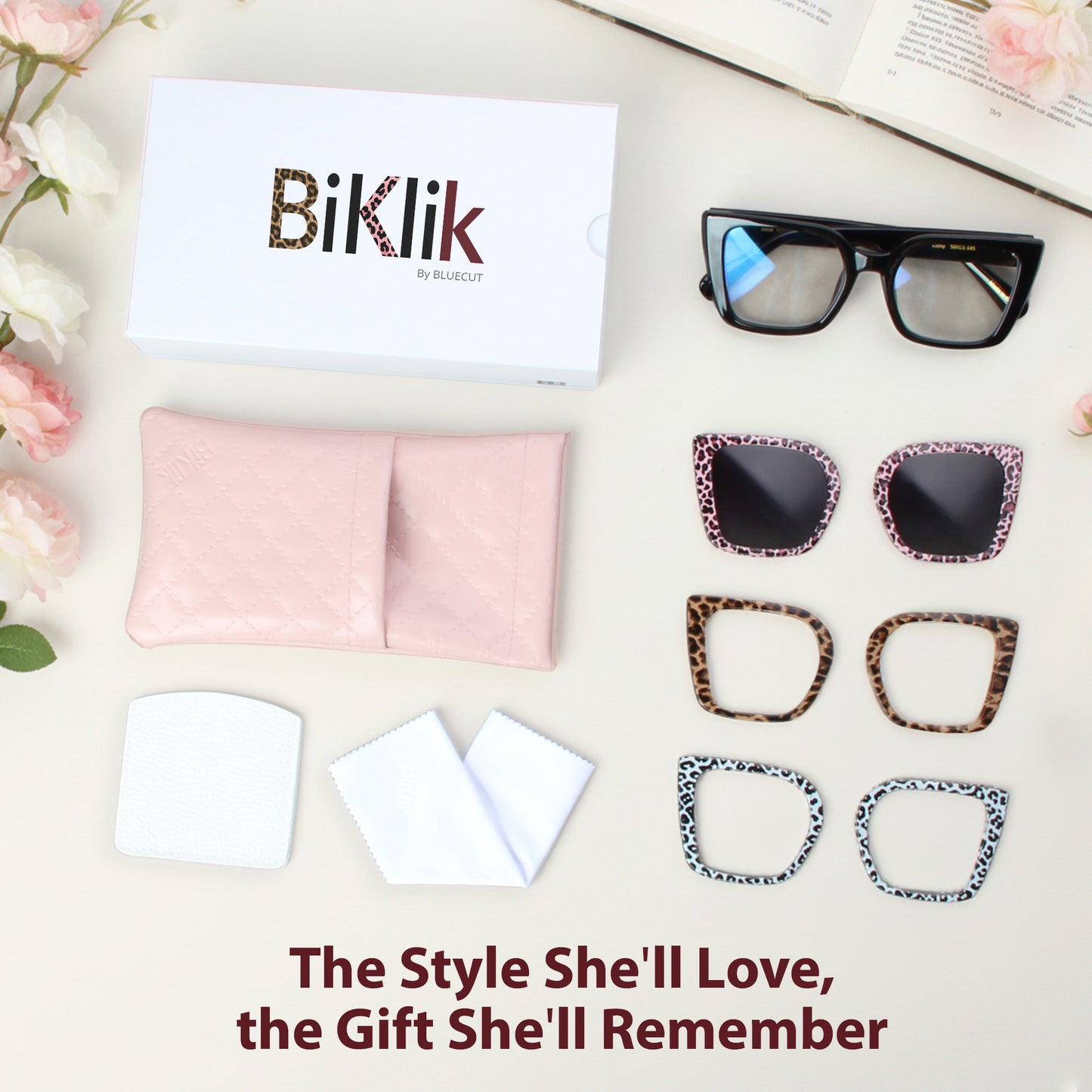 Sunglasses and lens frames with 'Biklik' branding on a light surface with flowers and packaging.