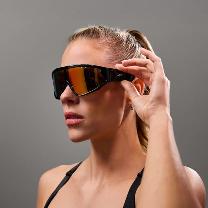 Woman touching the temple of Reebok Voltage red mirror sunglasses